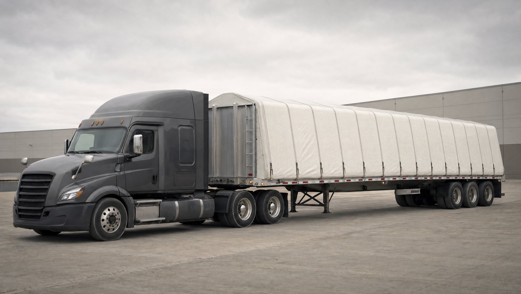 ASE North Logistics Conestoga trailer with its rolling tarp system closed over the deck