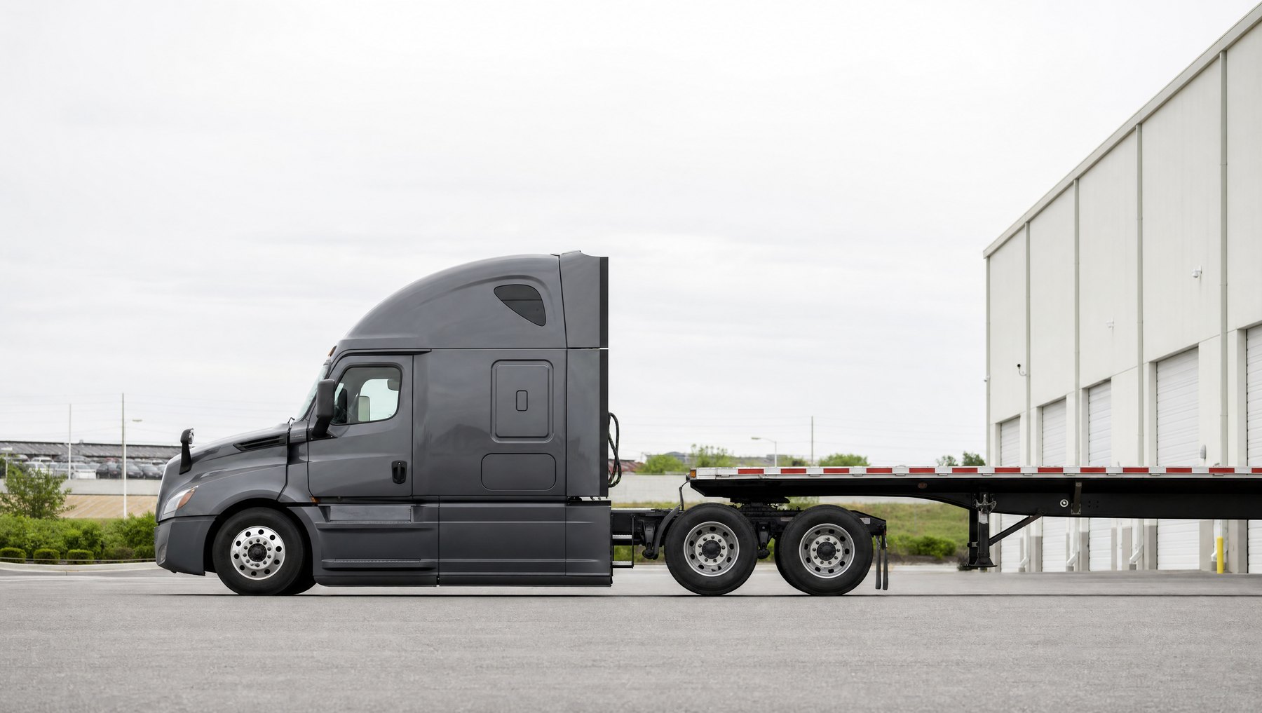 ASE North Logistics tractor with a flatbed trailer
